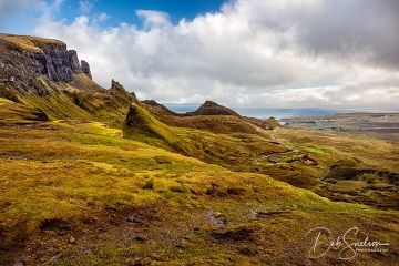The Quiraing in Trotternish, northern Isle of Skye, Scottish Highlands.  Blue sky in the distance quickly dissolved into another rain storm as I stood trying to maintain my balance in the high winds.  I fell twice, due to both the high wind and the slippery peat-covered ground.  Stunning area!